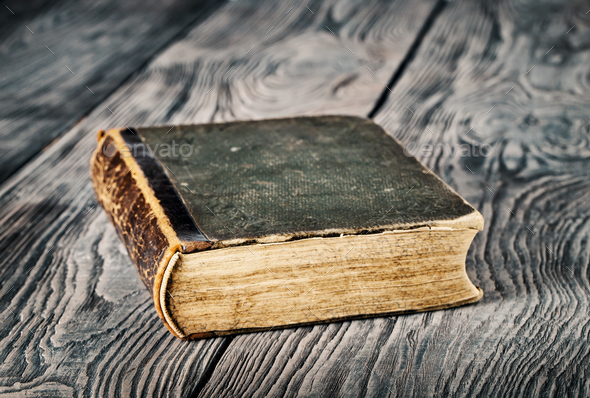 Ancient closed book with green cover